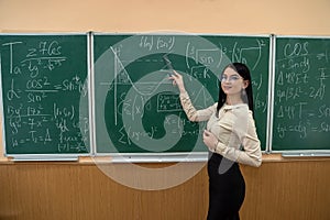 young teacher or student standing near blackboard and learn math lesson