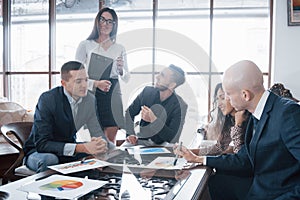 Young team of coworkers making great business discussion in modern coworking office. Teamwork people concept