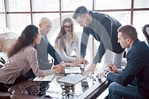 Young team of coworkers making great business discussion in modern coworking office. Teamwork people concept