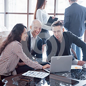 Young team of coworkers making great business discussion in modern coworking office. Teamwork people concept