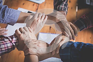 Young team putting hands up for new startup in creative office, Team Teamwork Togetherness Collaboration Co-working and teamwork