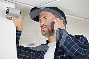 young technician adjusting cctv camera