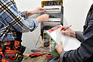 Young technician electrician and engineer check the voltage of a