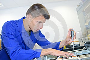 Young technician fix office photo copier