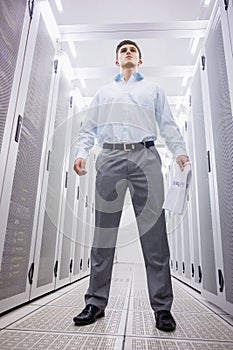 Young technician standing holding a document