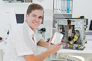 Young technician working on broken computer