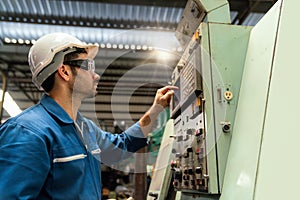 Young technicians factory worker controlling the work. Engineer checking and monitoring the electrical system in the industrial.