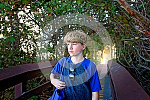 Young Teen Adolescent Boy with Serious Expression Walking Outside to Beach