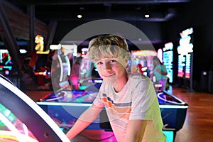 Young Teen Boy at Neon Video Game Arcade