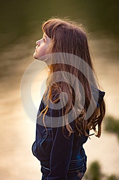 Young teen brunette girl with tears in her eyes with long hair s