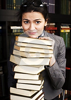 Young teen girl in library among books emotional close up bookwarm