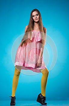 Young teen girl in a pink dress posing