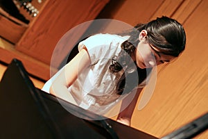 Young teen girl playing piano