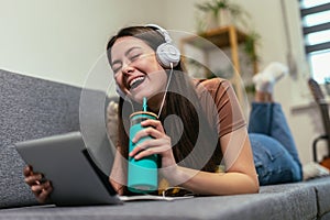 Girl using digital tablet computer listening music at home