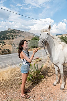 Young teen girl with white horse