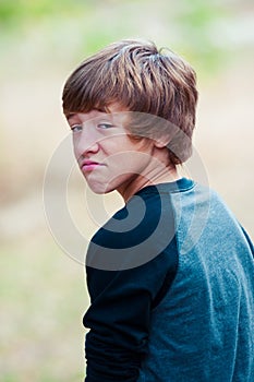 Young teen looking at camera with frown face