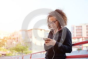 Young teen texting on her mobile phone photo