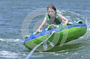 Young Teen Tubing Behind a Boat photo