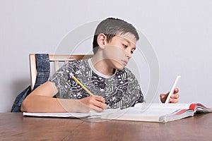 Young teenage boy doing his homework