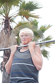 Young teenage boy doing pullups