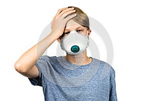 Young teenage boy with headache wearing protective mask