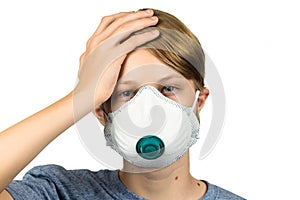 Young teenage boy with headache wearing protective mask