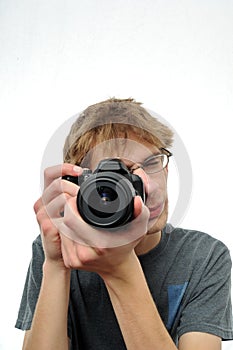 Young teenage boy holding Digital SLR Camera