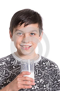 Young teenage boy with a milk moustache