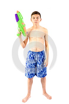 Young teenage boy playing with water guns