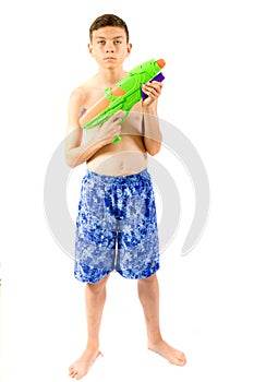 Young teenage boy playing with water guns