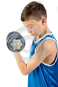 Young teenage boy using dumbbells