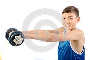 Young teenage boy using dumbbells