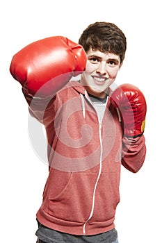 Young teenage boy wearing boxing gloves smiling