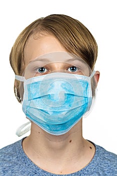 Young teenage boy wearing a protective mask. Isolated on white