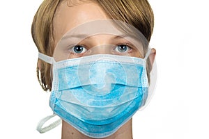 Young teenage boy wearing a protective mask. Isolated on white