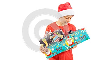 Young teenage boy wearing a Santa Christmas hat with a gift