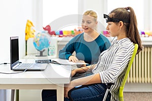 Young teenage girl and child therapist during EEG neurofeedback session. Electroencephalography concept.