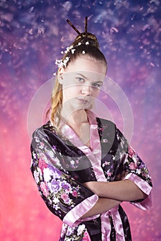 Young teenage girl in floral kimono in studio