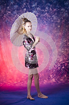 Young teenage girl in floral kimono in studio