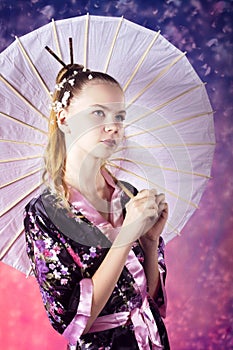 Young teenage girl in floral kimono in studio