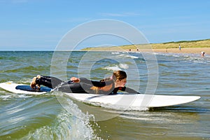 young teenage girl getting surf lessons on vacation.