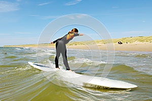 Young teenage girl getting surf lessons on vacation.