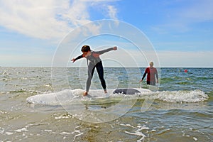 Young teenage girl getting surf lessons on vacation.