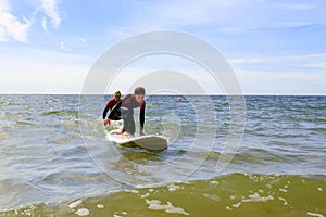 Young teenage girl getting surf lessons on vacation.