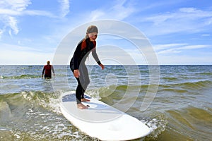 Young teenage girl getting surf lessons on vacation.