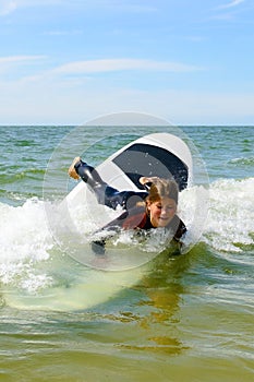 Young teenage girl have fun on vacation with surfing lessons.