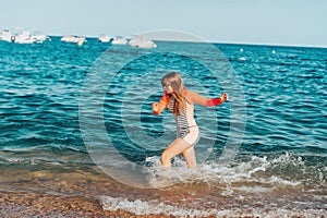 Young teenage girl having fun in the sea