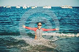 Young teenage girl having fun in the sea