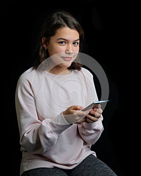 Young teenage girl holding cell phone