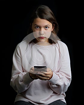 Young teenage girl holding cell phone